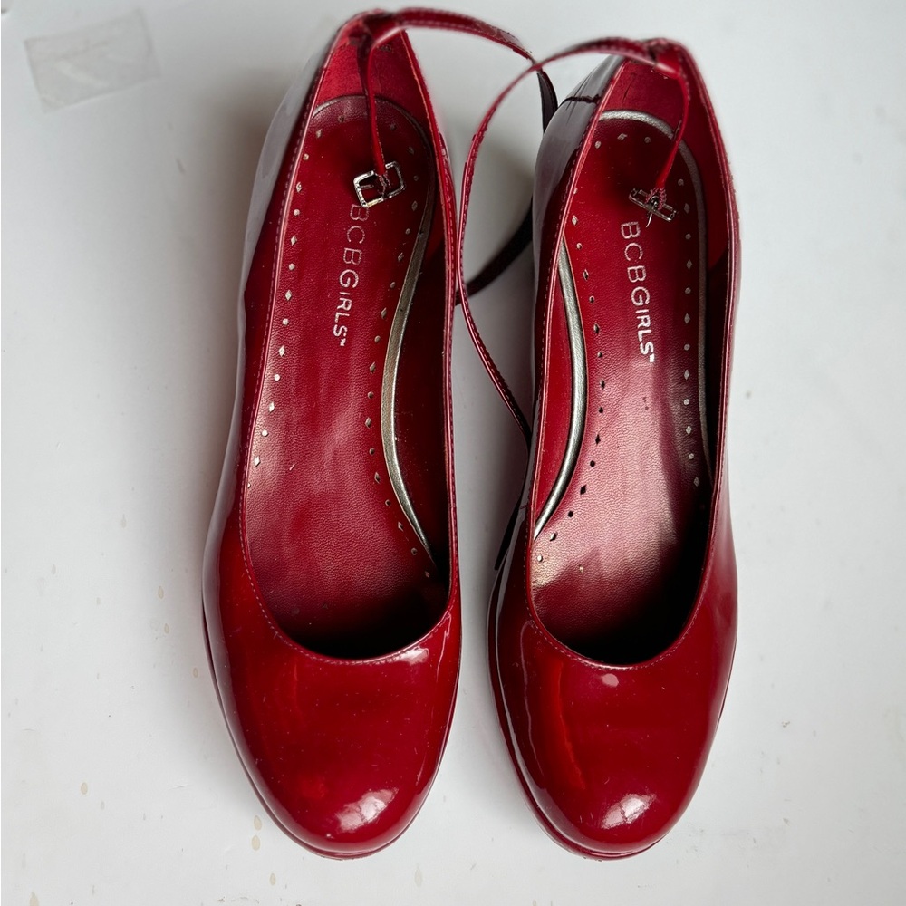 BCBGirls red wedge heel with an ankle strap size 7